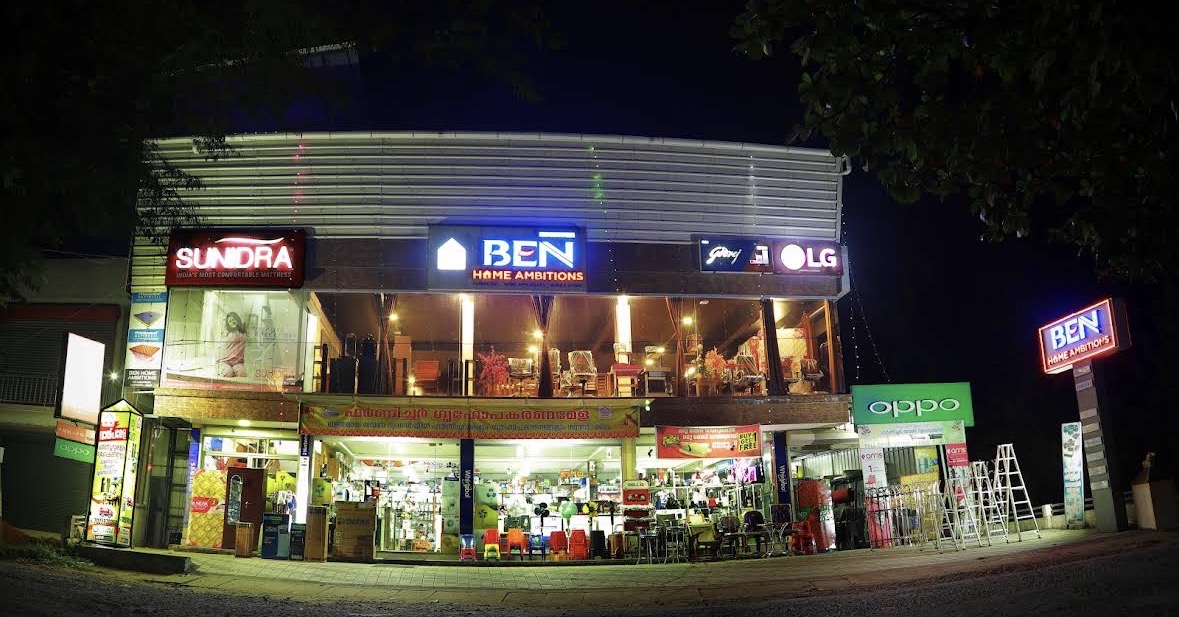 BEN Home Ambitions showroom with a glass frontage on a road in Mannoor, Ernakulam